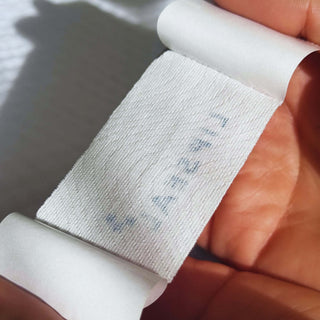 User peeling a LIPSEAL strip from the adhesive sheet before use